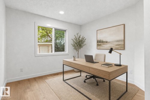Light-filled room featuring a single window with white trim, recessed ceiling lighting, and wood-finish flooring - 140 Healy Road Nw, Edmonton, AB - Indoor Photo Showing Office