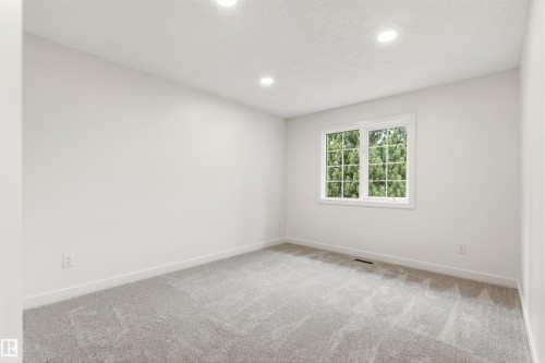 Bedroom with light gray carpet, white walls, recessed ceiling lighting, and a white-framed window - 140 Healy Road Nw, Edmonton, AB - Indoor Photo Showing Other Room