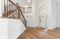 Entryway featuring a vaulted ceiling and wood-finish flooring - 