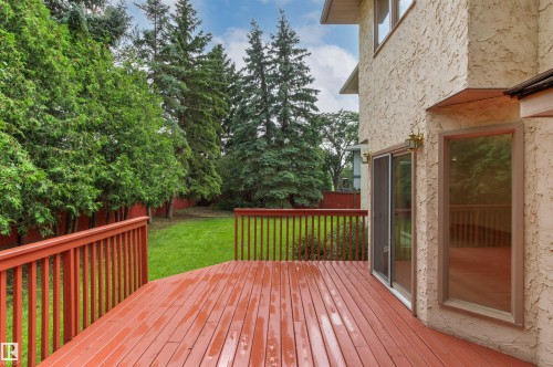 Expansive outdoor deck with rich red-toned wood decking and railing - 140 Healy Road Nw, Edmonton, AB - Outdoor With Deck Patio Veranda With Exterior