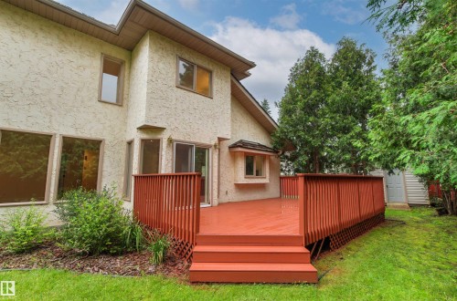 Expansive red-toned deck with built-in steps and lattice skirting - 140 Healy Road Nw, Edmonton, AB - Outdoor With Exterior