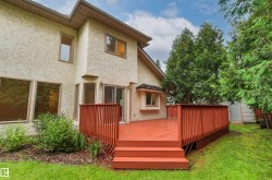 Expansive red-toned deck with built-in steps and lattice skirting - 