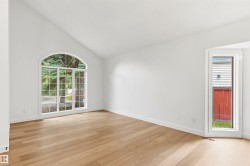 Vaulted ceiling with an arched window and a vertical window - 