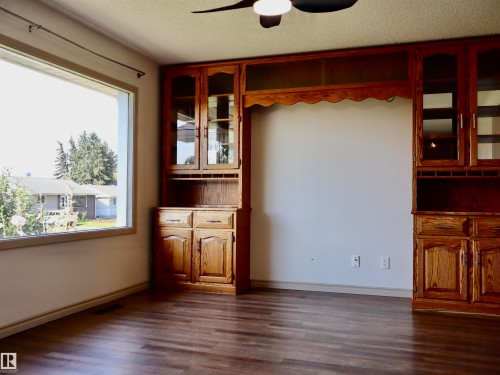 Expansive window providing abundant natural light, complemented by wood-finish flooring - 4306 - 55 Ave, Barrhead, AB - Indoor Photo Showing Other Room