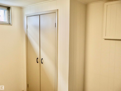 Built-in closet with double doors and black hardware - 4306 - 55 Ave, Barrhead, AB - Indoor Photo Showing Other Room