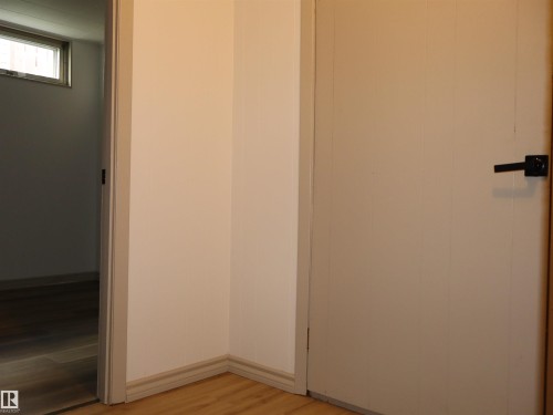 Interior space featuring light-toned walls and wood-finish flooring - 4306 - 55 Ave, Barrhead, AB - Indoor Photo Showing Other Room