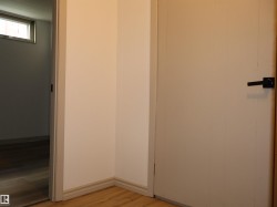 Interior space featuring light-toned walls and wood-finish flooring - 