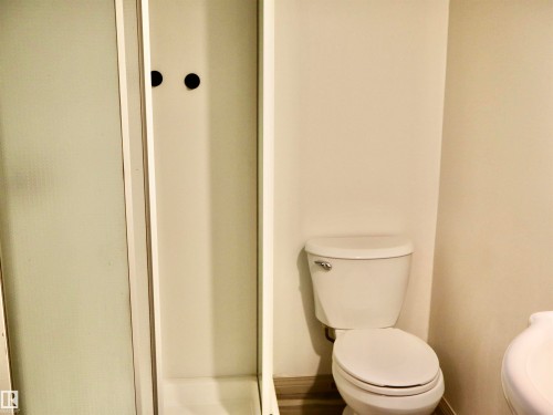 Shower enclosure with frosted glass paneling and a white porcelain toilet - 4306 - 55 Ave, Barrhead, AB - Indoor Photo Showing Bathroom