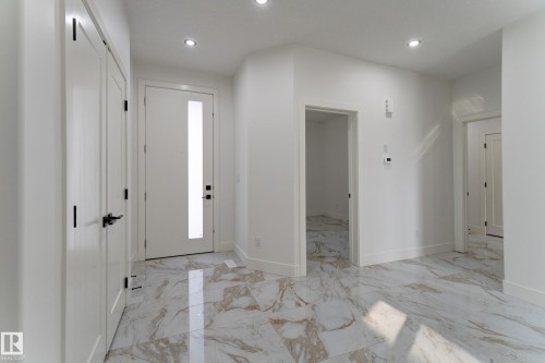 Entryway featuring large format marble-look tile flooring, white walls, and recessed lighting - 4723 17 Avenue Sw, Edmonton, AB - Indoor Photo Showing Other Room