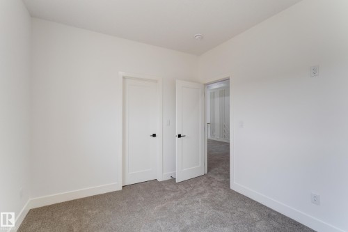 Room featuring light gray carpet flooring, white walls, and bright white trim - 4723 17 Avenue Sw, Edmonton, AB - Indoor Photo Showing Other Room