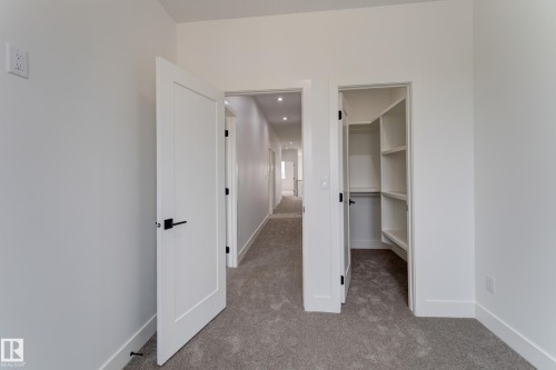 Interior space featuring a walk-in closet with built-in shelving and hanging rod - 4723 17 Avenue Sw, Edmonton, AB - Indoor Photo Showing Other Room