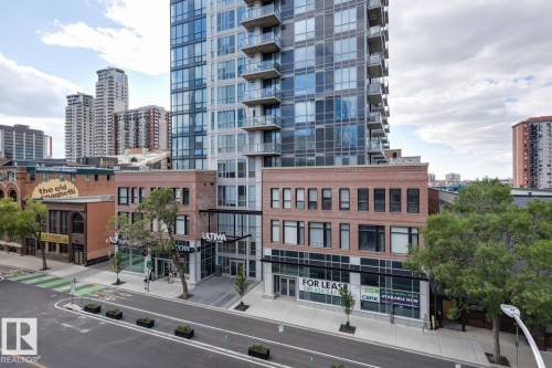 Modern high-rise residential building featuring a glass and concrete facade with private balconies - #910 10238 103 St Nw, Edmonton, AB - Outdoor With Facade