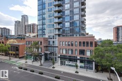 Modern high-rise residential building featuring a glass and concrete facade with private balconies - 