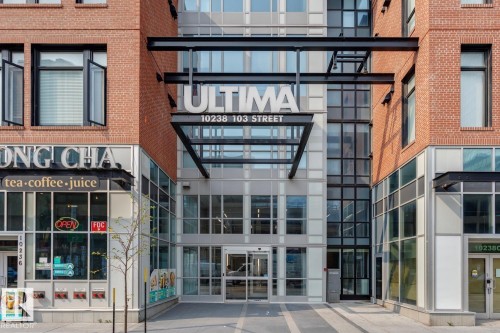 Modern commercial building facade featuring brick and glass construction - #910 10238 103 St Nw, Edmonton, AB - Outdoor With Facade