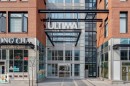 Modern commercial building facade featuring brick and glass construction - #910 10238 103 St Nw, Edmonton, AB  - Outdoor With Facade 
