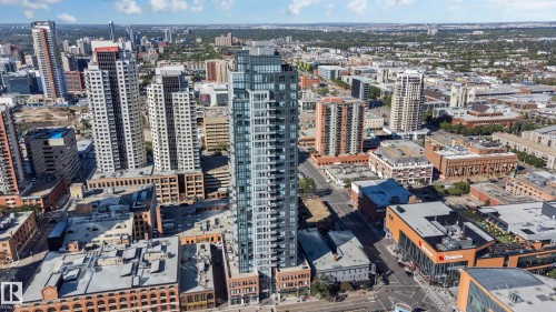 Modern high-rise with extensive glass facade, featuring numerous balconies and a flat roofline - #910 10238 103 St Nw, Edmonton, AB - Outdoor With View