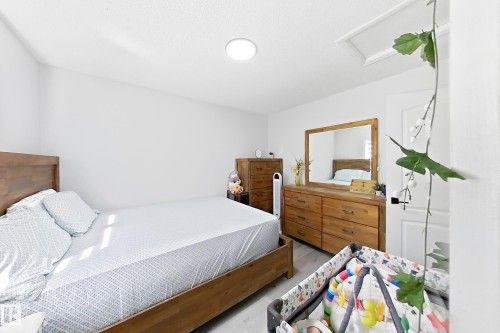 Bedroom featuring light-toned flooring, white walls, and a sloped ceiling - 3799 21 Street Nw, Edmonton, AB - Indoor Photo Showing Bedroom