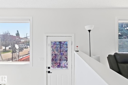 White entry door with decorative glass panel - 3799 21 Street Nw, Edmonton, AB - Indoor Photo Showing Other Room
