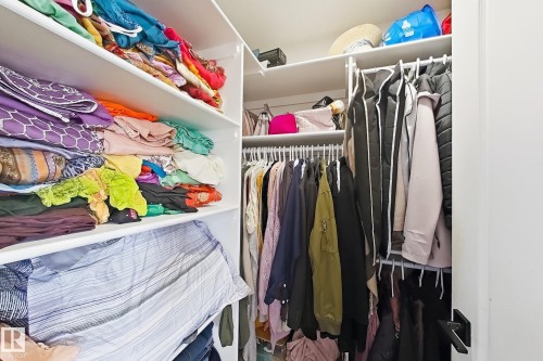 Custom closet storage system featuring multiple shelving units and hanging rods - 3799 21 Street Nw, Edmonton, AB - Indoor With Storage
