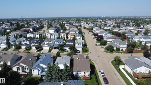 Residential neighborhood featuring detached homes with varied architectural styles, mature landscaping, and paved streets - 3799 21 Street Nw, Edmonton, AB - Outdoor With View