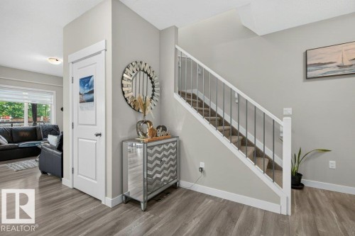 Staircase with white railing and dark metal spindles - 848 Ebbers Crescent Nw, Edmonton, AB - Indoor Photo Showing Other Room