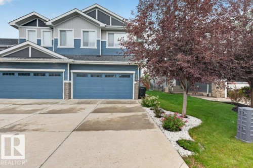 Blue and light gray exterior siding with gable rooflines and white window trim - 848 Ebbers Crescent Nw, Edmonton, AB - Outdoor