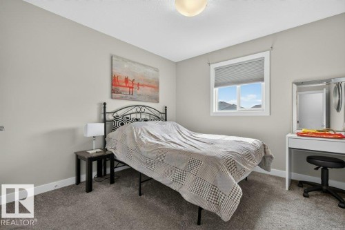 Carpeted interior space featuring a window with cellular blinds, a ceiling-mounted light fixture, and light-toned walls - 848 Ebbers Crescent Nw, Edmonton, AB - Indoor Photo Showing Bedroom
