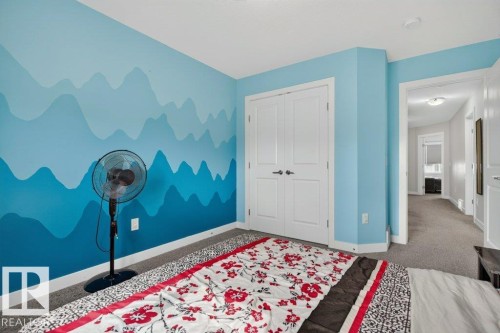 Interior room featuring a painted accent wall, white trim, and light gray carpet - 848 Ebbers Crescent Nw, Edmonton, AB - Indoor Photo Showing Bedroom