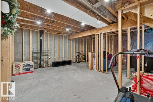 Unfinished basement space featuring exposed wood framing, concrete foundation walls, and a concrete floor - 848 Ebbers Crescent Nw, Edmonton, AB - Indoor Photo Showing Basement