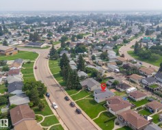 Residential neighborhood with mature trees, established properties, and paved streets - 
