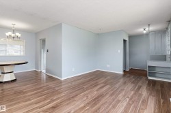 Spacious room featuring wood-finish flooring and light-toned walls - 