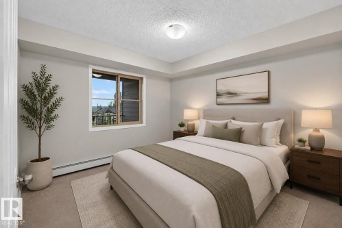 Neutral color palette with textured wall-to-wall carpeting and a window offering natural illumination - #404 12025 22 Av Sw, Edmonton, AB - Indoor Photo Showing Bedroom