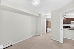 Carpeted interior space with light-toned walls - 