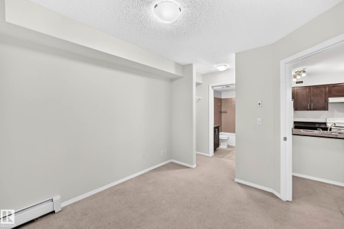 Carpeted interior space with light-toned walls - #404 12025 22 Av Sw, Edmonton, AB - Indoor