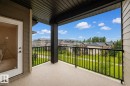 Private balcony with durable flooring, black metal railing, and a glass-paneled door - #404 12025 22 Av Sw, Edmonton, AB  - Outdoor With Balcony With Facade 
