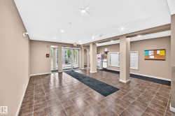 Building entry featuring tile flooring, neutral wall tones, recessed lighting, and glass-paned doors - 