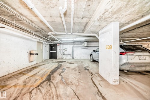 Concrete subterranean parking structure featuring exposed utility piping - #404 12025 22 Av Sw, Edmonton, AB 