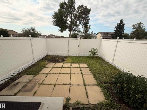 Fenced backyard featuring a paver patio area and a separate gate - 11430 139 Avenue Nw, Edmonton, AB - Outdoor