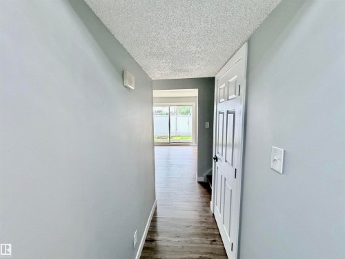 Hallway featuring wood-finish flooring, light gray walls, and white trim - 11430 139 Avenue Nw, Edmonton, AB - Indoor Photo Showing Other Room