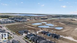 Aerial perspective showcasing a developing residential area with multiple water features - 