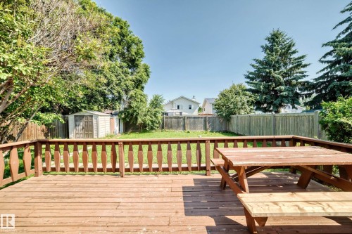 Wood-finish deck featuring a decorative railing and expansive grass lawn - 6208 11 Ave Nw Nw, Edmonton, AB - Outdoor With Deck Patio Veranda