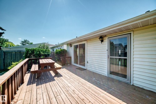 Expansive wooden deck featuring horizontal planking and a matching railing - 6208 11 Ave Nw Nw, Edmonton, AB - Outdoor With Deck Patio Veranda With Exterior