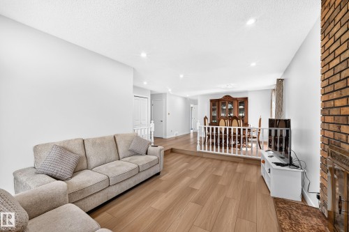 Open-concept living area featuring wood-finish flooring and recessed lighting - 6208 11 Ave Nw Nw, Edmonton, AB - Indoor Photo Showing Living Room