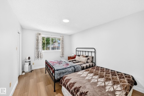 Recessed lighting illuminates wood-finish flooring - 6208 11 Ave Nw Nw, Edmonton, AB - Indoor Photo Showing Bedroom