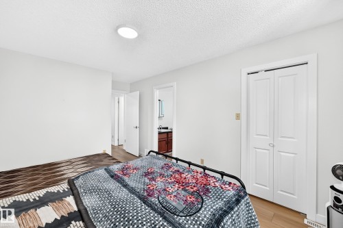 Bedroom featuring wood-finish flooring and a ceiling-mounted light fixture - 6208 11 Ave Nw Nw, Edmonton, AB - Indoor Photo Showing Bedroom