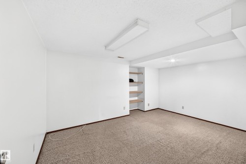 Neutral tone carpet flooring with white painted walls - 6208 11 Ave Nw Nw, Edmonton, AB - Indoor Photo Showing Other Room