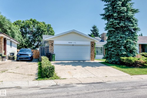 Ranch-style residence featuring a two-car garage, brick facade accents, a concrete driveway, and mature landscaping - 6208 11 Ave Nw Nw, Edmonton, AB - Outdoor