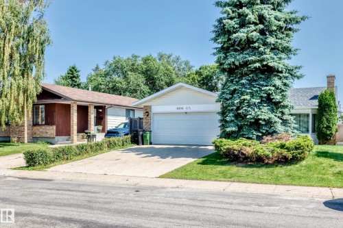 Single-story residence featuring a two-car garage, concrete driveway, and a front lawn with mature trees and established landscaping - 6208 11 Ave Nw Nw, Edmonton, AB - Outdoor
