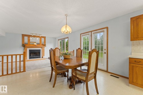 11 Heritage Boulevard, St. Albert, AB - Indoor Photo Showing Dining Room With Fireplace