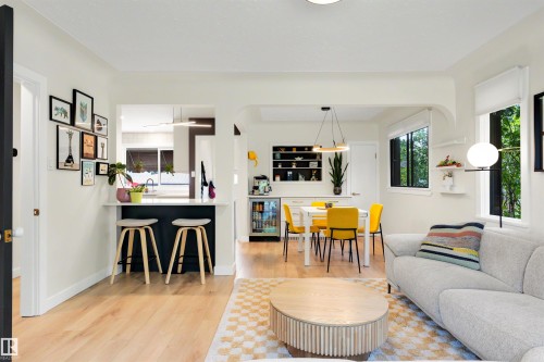 Bright interior space featuring light wood-finish flooring, white walls, multiple windows, and recessed lighting - 10732 129 Street Nw, Edmonton, AB - Indoor Photo Showing Living Room